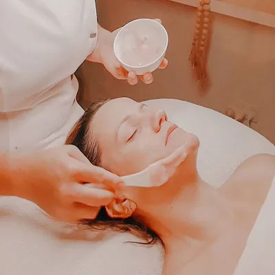 Bec applying cream during facial